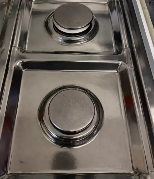 After: the same stovetop burners, degreased